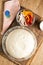 Ingredients for pizza: dough in a bowl, mushrooms, a glass with flour.