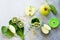 Ingredients for the preparation of green smoothies - apple, kiwi, spinach, pine nuts. Proper nutrition.