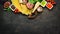 Ingredients for the preparation of Lasagna. Tomatoes, sauce, pasta. On a black background. Top view.