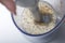 Ingredients for the preparation of mayonnaise are placed in the blender bowl: French mustard, egg, and sunflower oil. View from ab