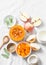 Ingredients for pumpkin apple soup on white background, top view. Pumpkin, apples, cream, onion, sage - ingredients