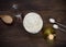 Ingredients for recipe pizza dough on dark wooden background.