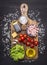 Ingredients for risotto with ham, vegetables and spices on a cutting board on wooden rustic background top view close up