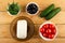 Ingredients for salad. Dill, black olives, cucumbers and tomato, feta cheese on table. Top view