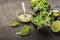 Ingredients for salad: rucola, root salad, olive oil, limes on a dark background. Seasonal Healthy Eating.