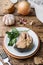 Ingredients for salmon fish soup, pieces of bread, onion and garlic with greens on wooden background