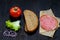 Ingredients for sandwich: bread, tomato, salami, salad, onion