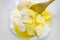 ingredients for shortcrust pastry as flour, eggs, butter and sugar with a stirring spoon in a bowl, baking background, view from