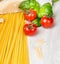 Ingredients for spaghetti cooking with tomates,basil leaves and parmesan