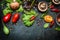 Ingredients for tasty salad making: lettuce leaves,champignons, tomatoes, herbs and spices on dark rustic background, top view