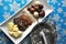 Ingredients and tools for making chocolates on winter background with snow flakes