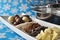 Ingredients and tools for making chocolates on winter background with snow flakes