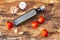 Ingredients of traditional Italian cuisine. Olive oil, tomatoes, garlic. Cooking wooden bark background