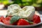 Ingredients for vegetarian caprese salad, ball of buffalo mozzarella cheese, fresh basil, tomatoes. Italian food served outdoor on