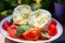 Ingredients for vegetarian caprese salad, buffalo mozzarella cheese, fresh basil, tomatoes, olive oil. Italian food served outdoor