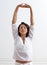 Inhale confidence, exhale doubt. Shot of a beautiful young woman stretching during a yoga session.