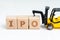 Initial Public Offerings, company going public in stock market, cube wooden block with alphabets combine the word IPO with