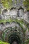 The Initiation Well vertical view with blurred tourist