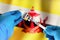 Injecting dose of vaccine in syringe for infections prevention in front of the Brunei flag