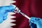 Injecting dose of vaccine in syringe for infections prevention in front of the Qatar flag