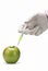 Injecting a fluid into an apple.