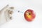 Injection into red apple - Genetically modified fruit and syringe with red chemical. GMO food. Laboratory research and fruit