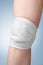 Injured female knee with bandage