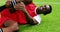 Injured football player lying on grass