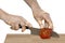 Injured hands with knife cutting a tomato