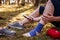 Injured hiker with sprain ankle using smart phone to get help