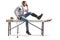 Injured man with an orthopedic boot sitting on a therapy table and holding his head