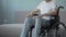 Injured man in wheelchair at health rehabilitation center, hopes to walk again