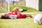 Injured, pain or injury of a female soccer player lying on a field holding her knee during a match. Hurt woman