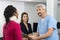 Injured Patient Consulting Doctor At Reception Desk