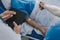 Injured patient showing doctor broken wrist and arm with bandage in hospital office or emergency room. Sprain, stress fracture or