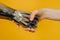 Injured person with bionic prosthesis joins hands with woman