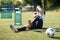 Injured soccer player with ball on football field