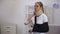 Injured woman in foam cervical collar and arm sling suffering pain in neck rehab