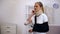 Injured woman in foam cervical collar and arm sling suffering pain in shoulder