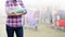 Injured woman with green cast on hand and arm on blurred background traveler with suitcase in airport, insurance travel