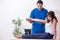 Injured woman visiting young male doctor osteopath