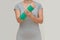 Injury woman wearing sportsware with green cast on hand and arm, body injury concept