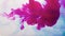 Ink pour in water magenta pink steam flow white