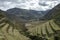 Inka ruins with Andens, stair-step like agricultural terrace dugs into the slope of a hillside in Pisac Archeological park, Peru