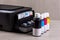 Inkjet four-color printer with continuous ink supply and ink bottles for refilling.