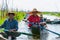 Inle Lake locals paddling traditional boats along channel