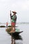 Inle Lake Myanmar 12/16/2015 fisherman standing on end of his boat with pole