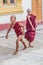 INLE, MYANMAR - NOVEMBER 28, 2016: Buddhist novices are playing at Alodaw Pauk Pagoda on Inle lake, Myanm