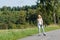 Inline skating young woman on sunny asphalt road