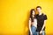 Inlove couple posing in fashion style on yellow wall